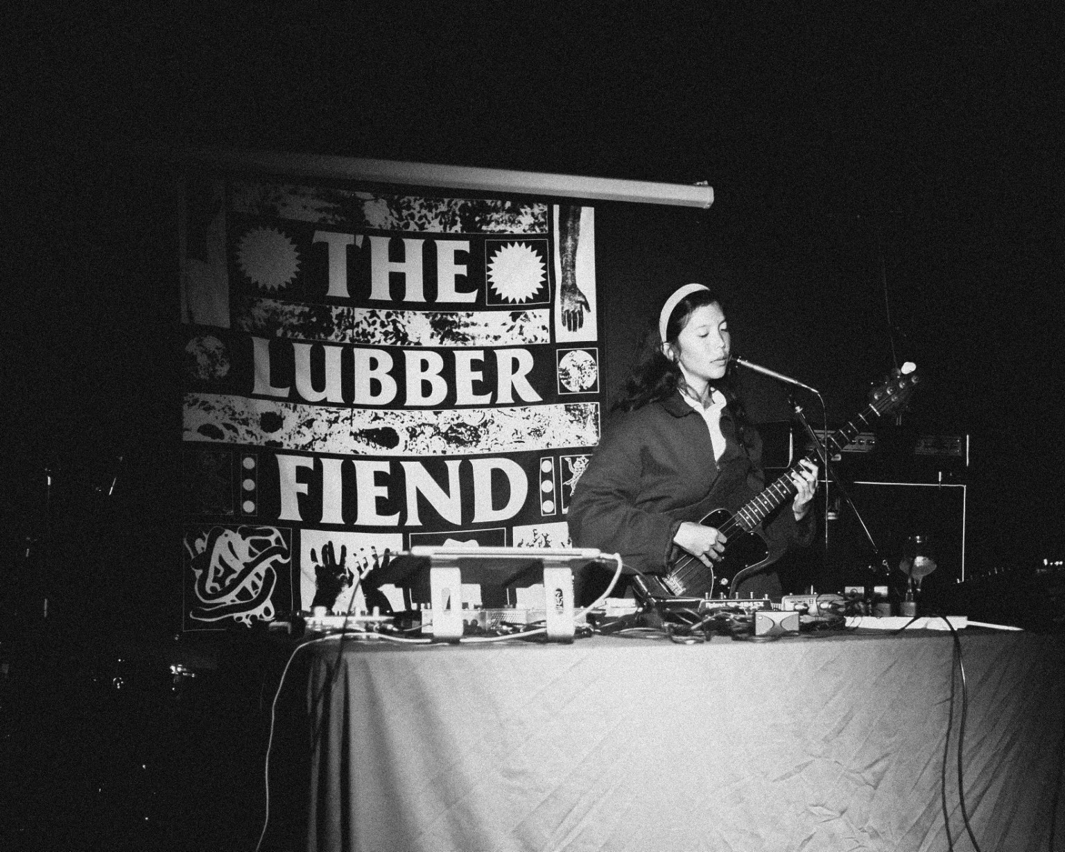 Performer at the Lubber Fiend with the venue sign behind them
